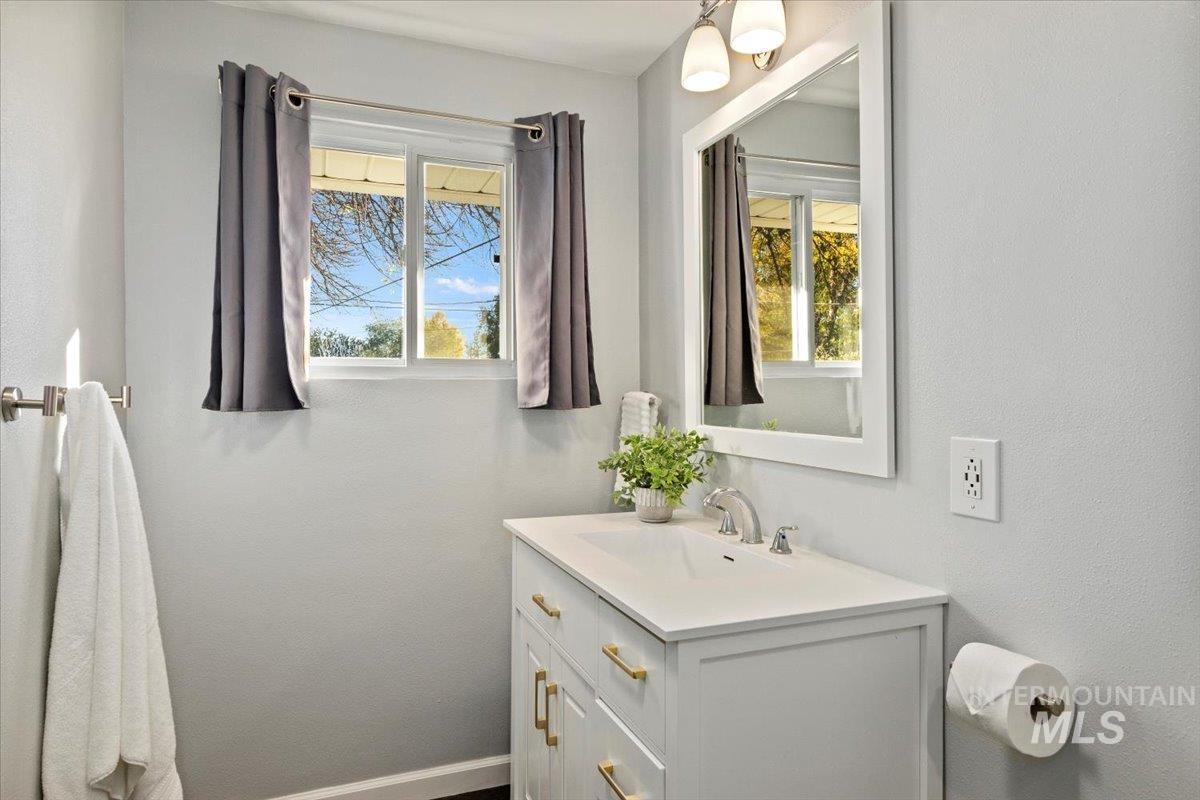 Bathroom featuring vanity and a textured wall