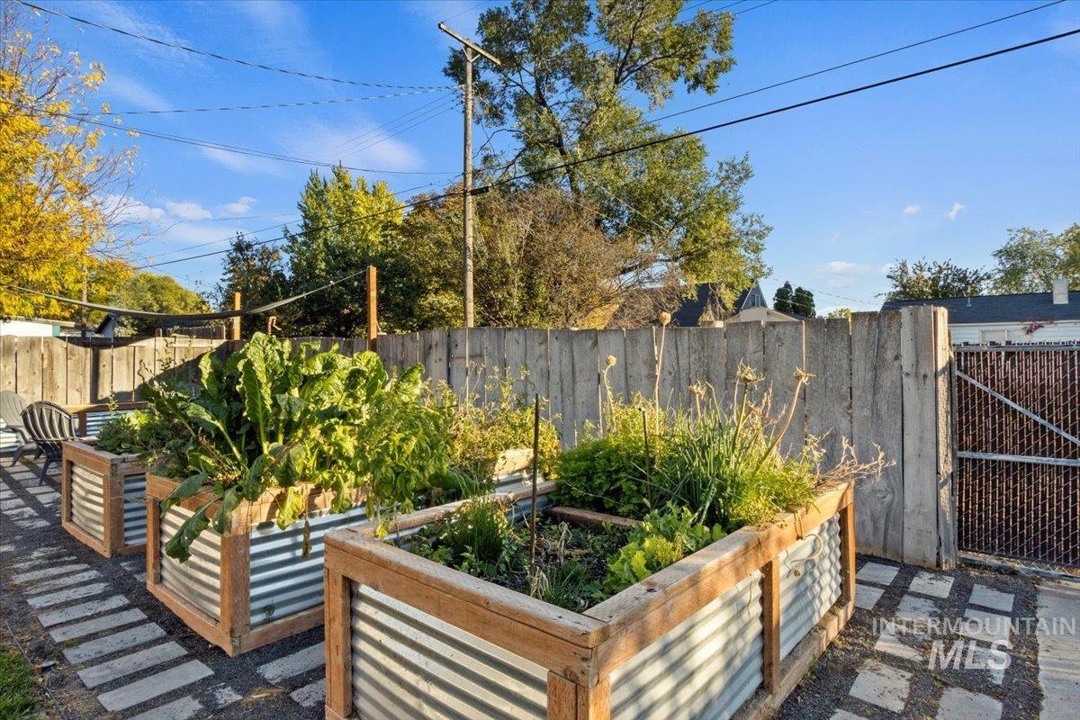 Fenced backyard featuring a garden and a patio