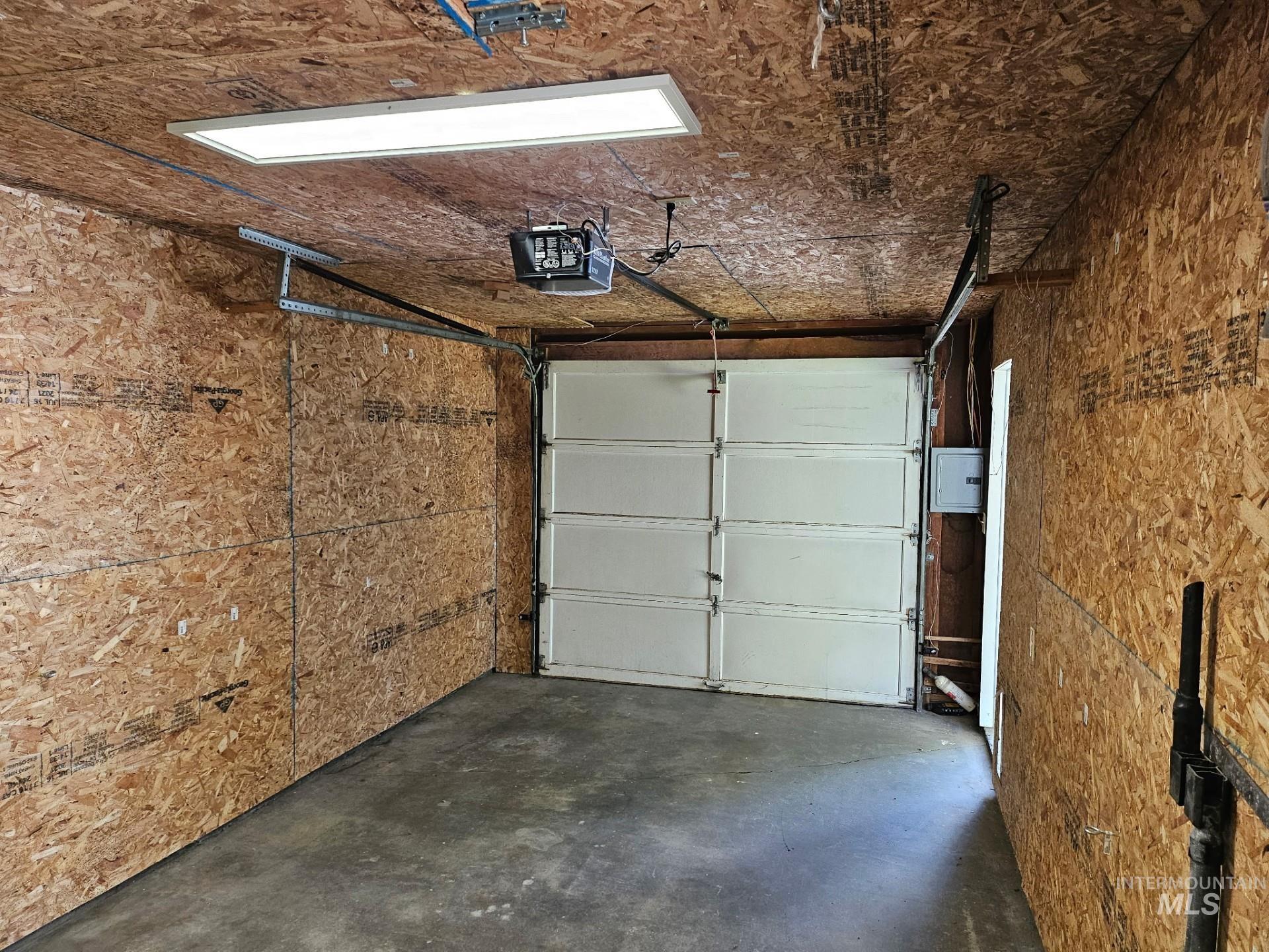 Garage featuring a garage door opener
