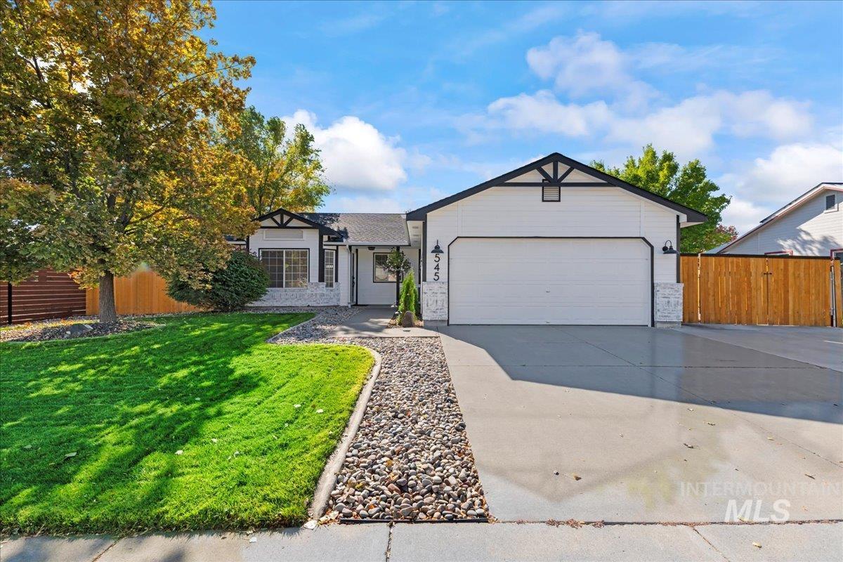 Ranch-style home with driveway and a garage