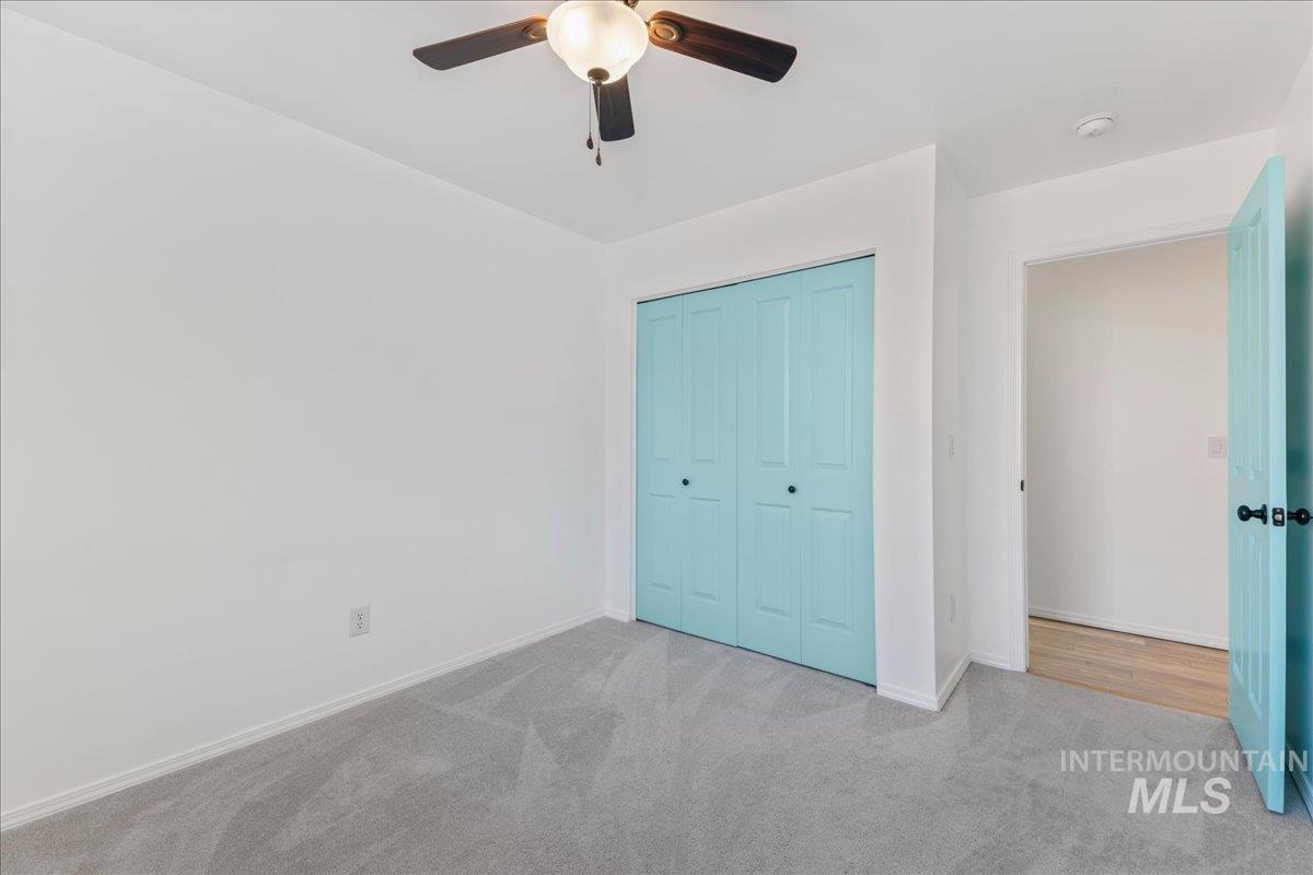 Unfurnished bedroom with carpet floors, a closet, and ceiling fan