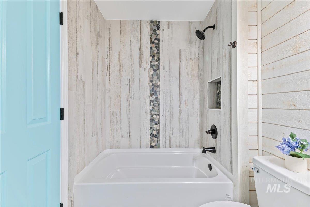 Bathroom with toilet and tub / shower combination