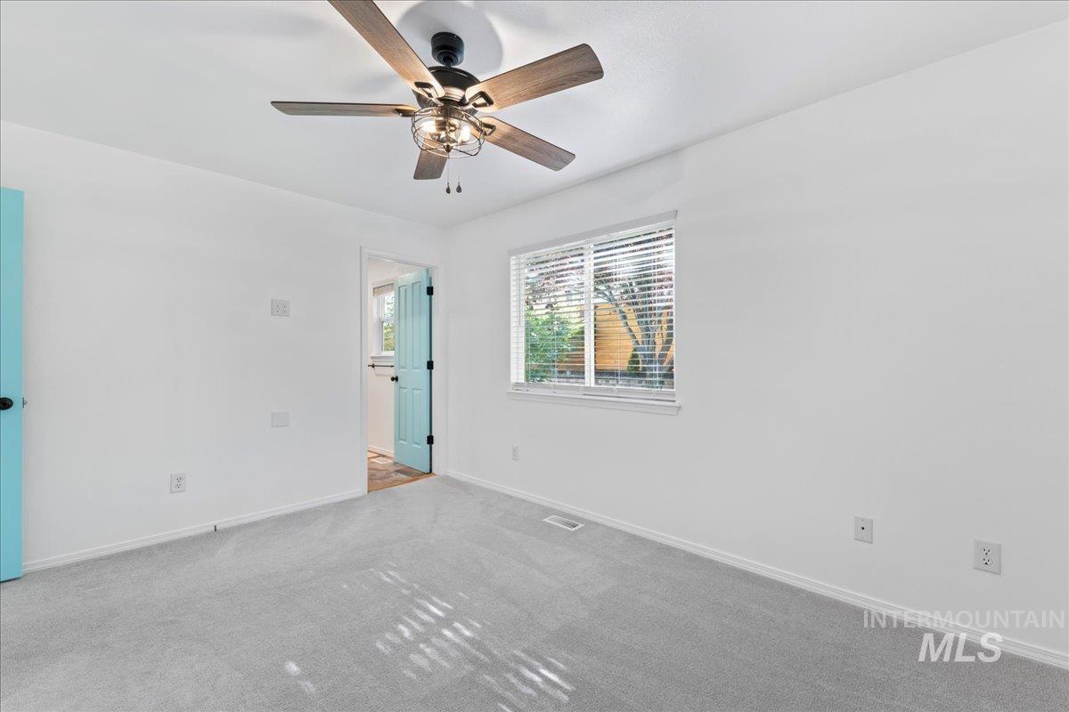 Unfurnished bedroom featuring carpet and a ceiling fan