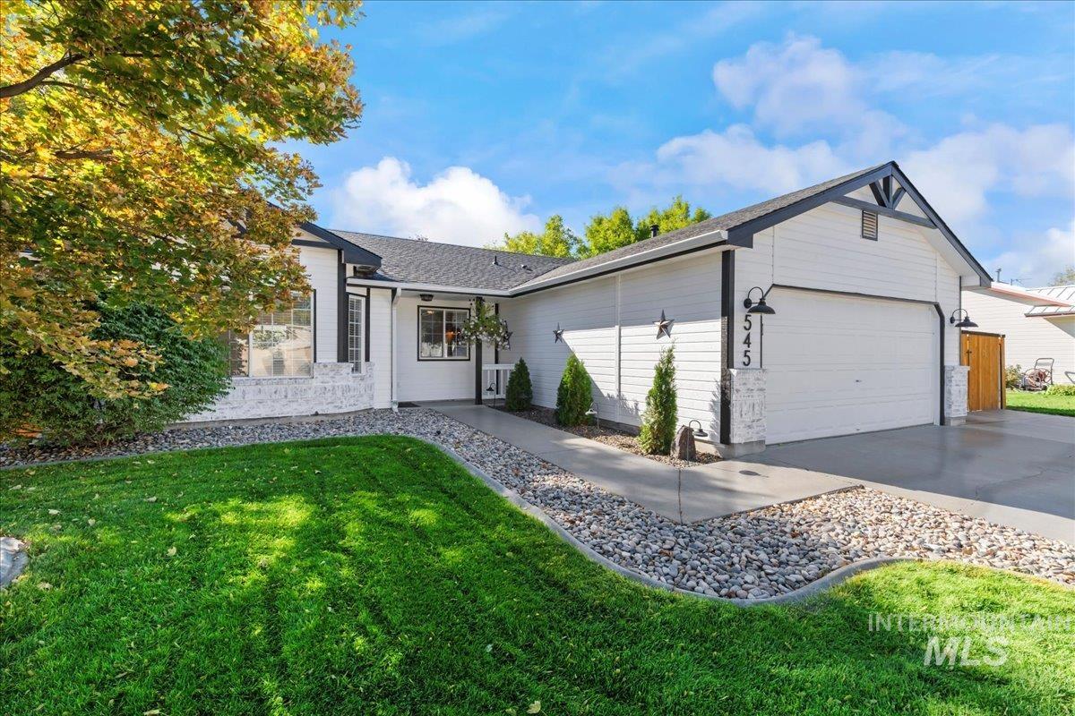 Single story home with a front lawn, driveway, a garage, and roof with shingles