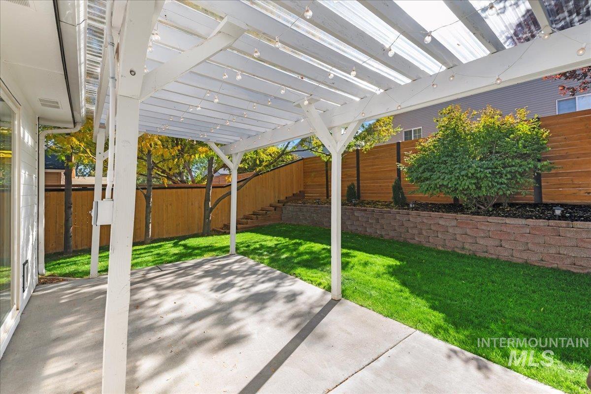 Fenced backyard featuring a patio area and a pergola