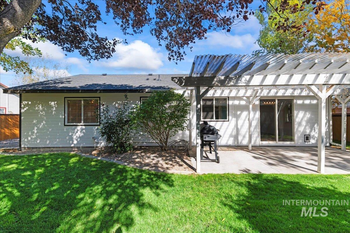 Back of property featuring a pergola and a patio