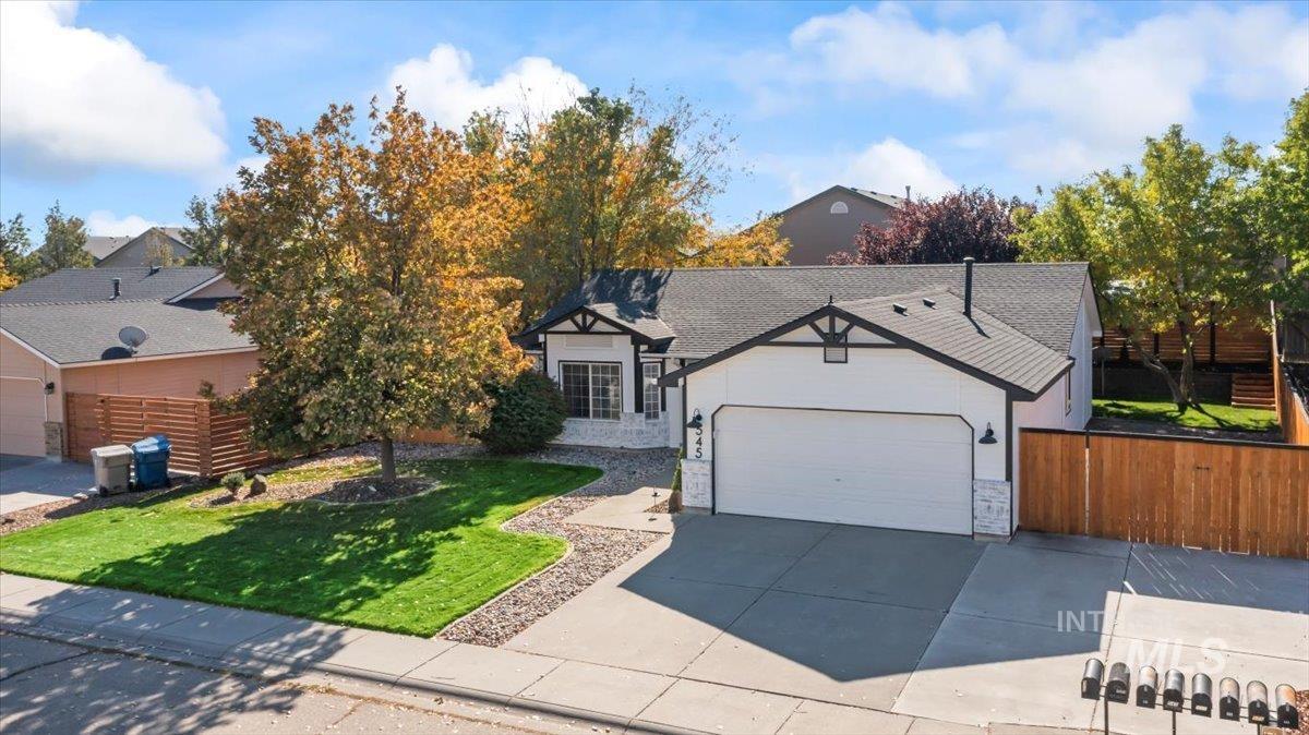 View of front of house featuring stone siding and driveway