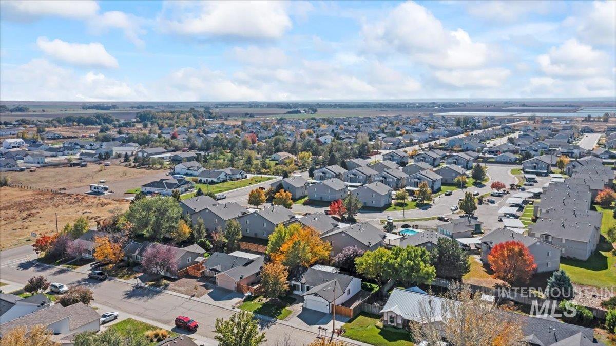 Aerial view of property and surrounding area with nearby suburban area