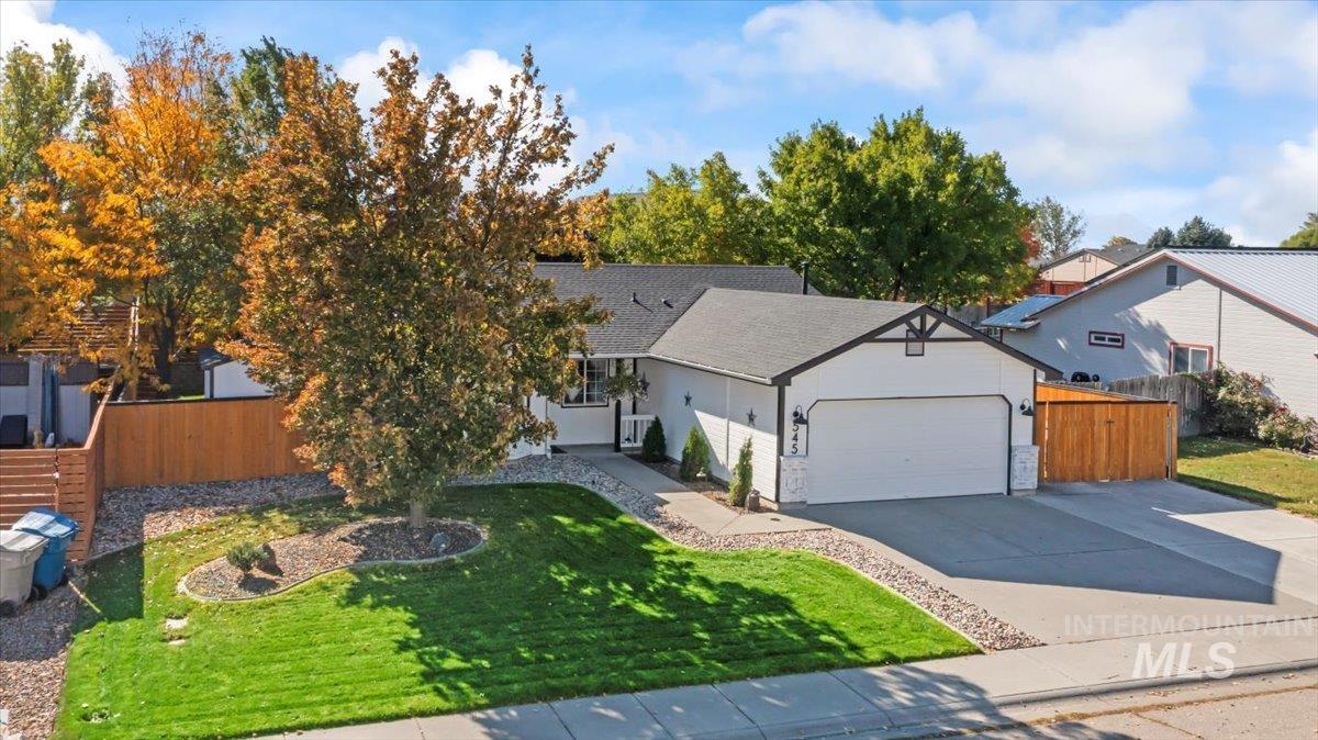 View of front of property featuring driveway, a garage, and roof with shingles