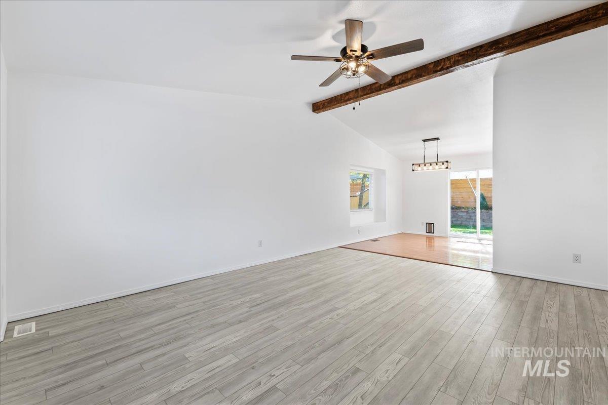 Unfurnished living room with light wood finished floors and ceiling fan
