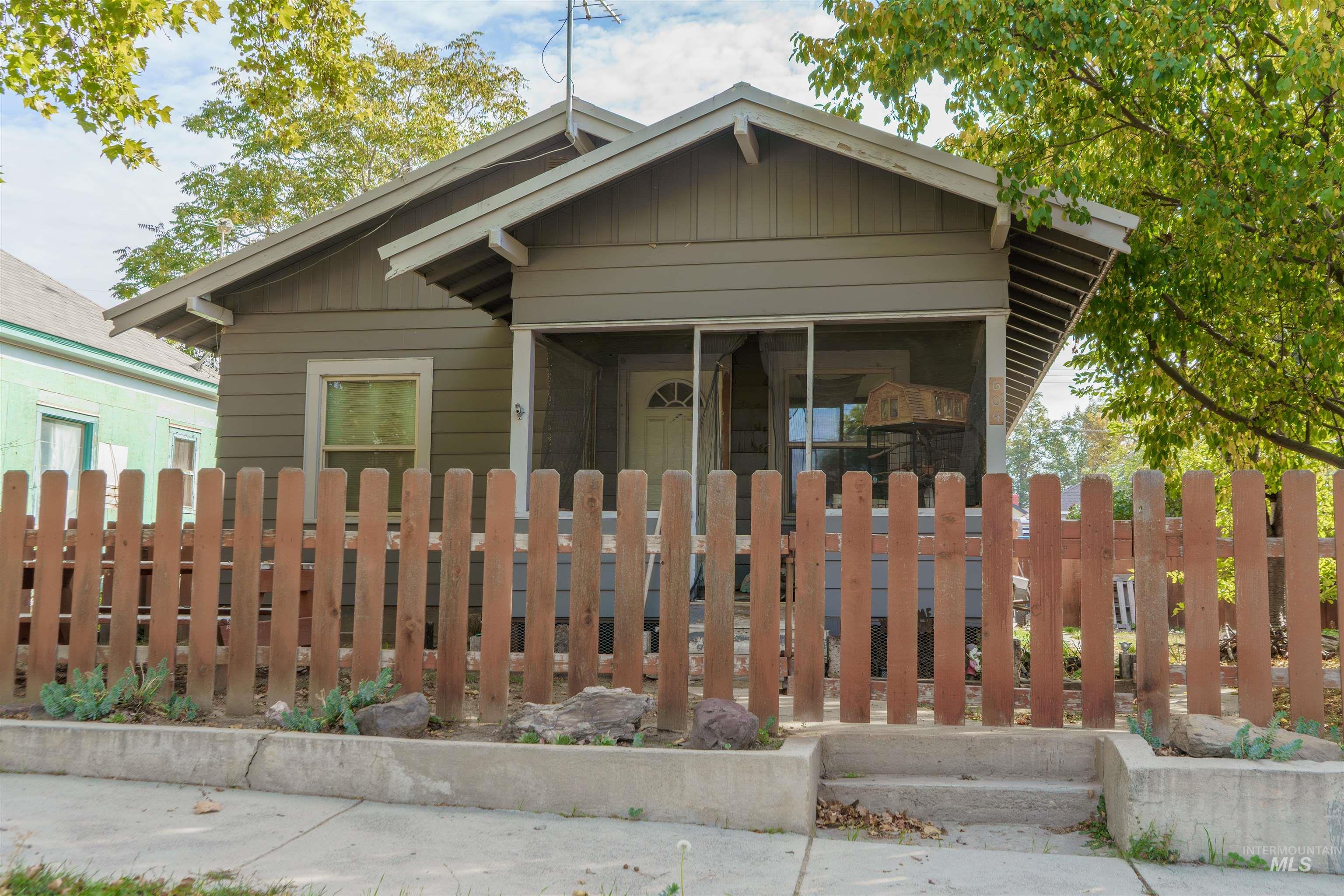 View of front facade featuring a fenced front yard and board and batten siding