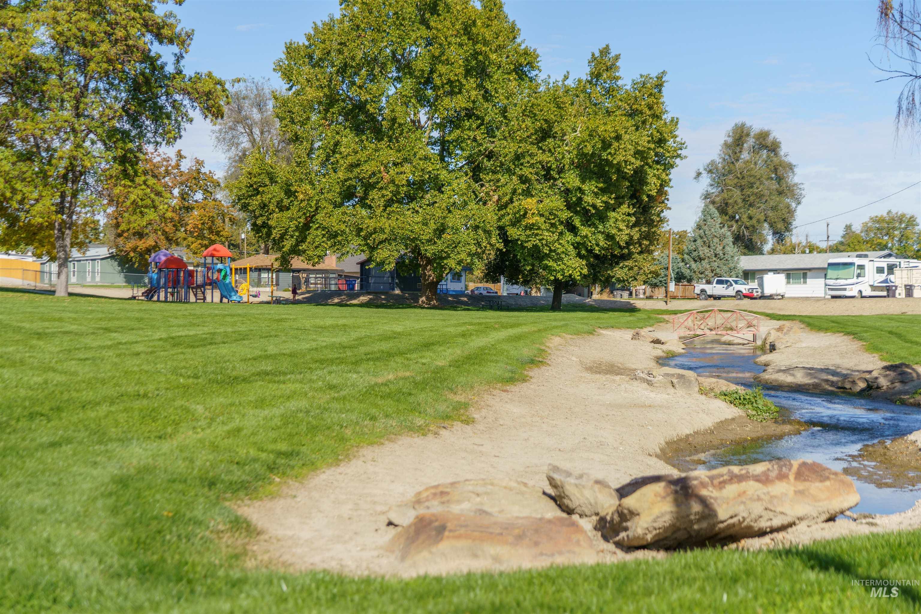View of property's community with a lawn