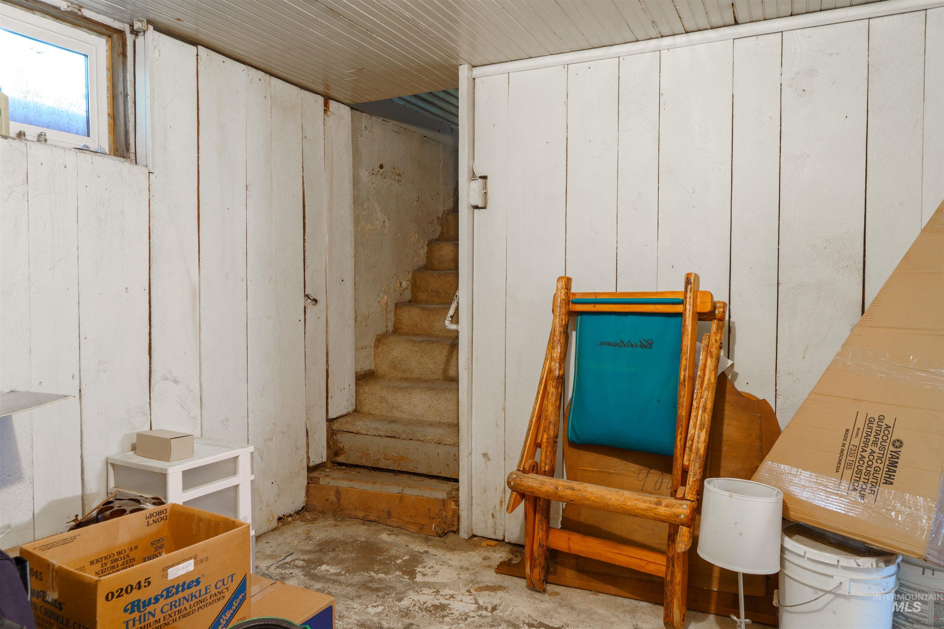 Stairway featuring wood walls