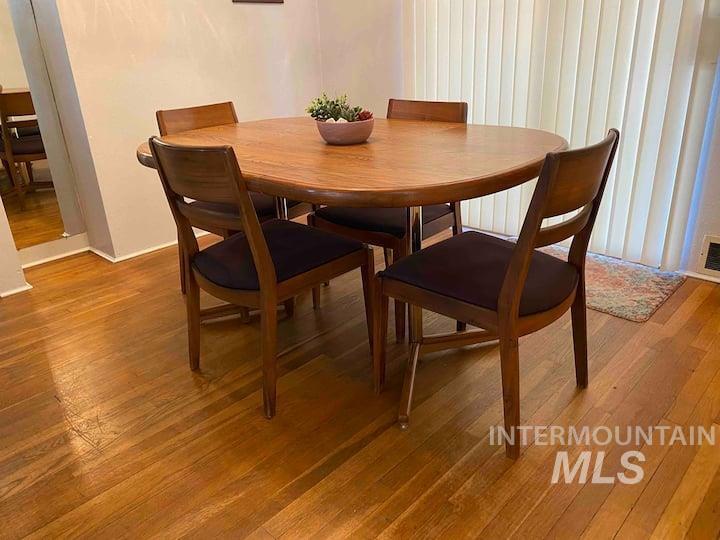 Dining area with light wood finished floors and baseboards