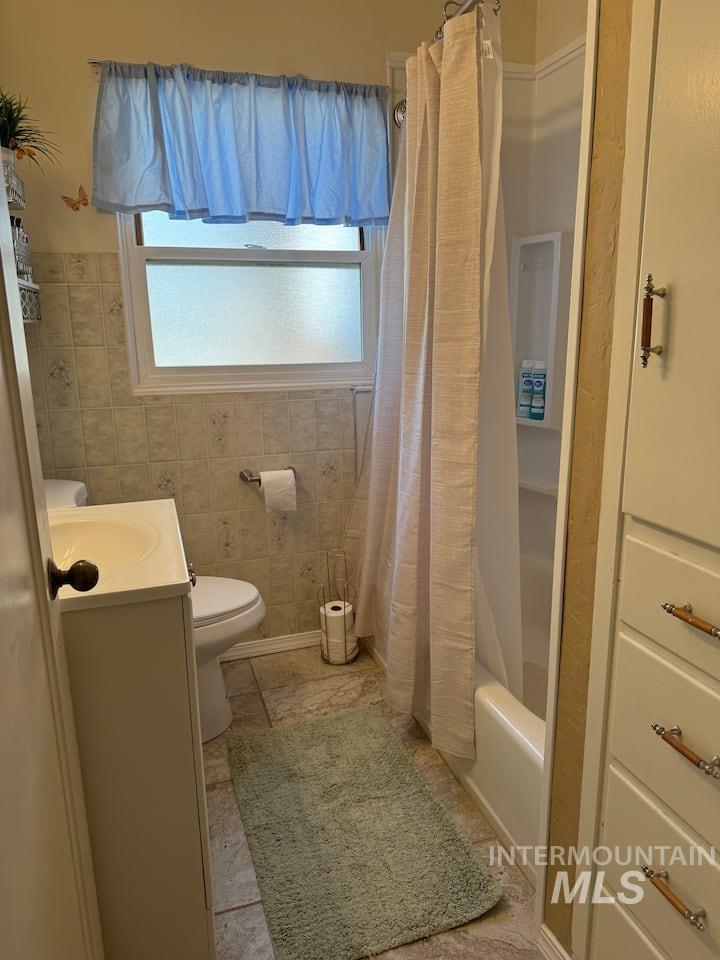 Full bath featuring vanity and shower / bathtub combination with curtain
