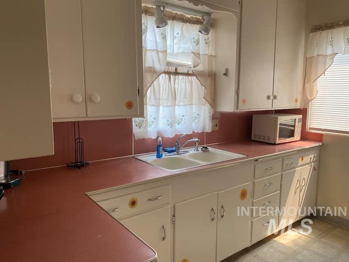 Kitchen with light countertops and white cabinets