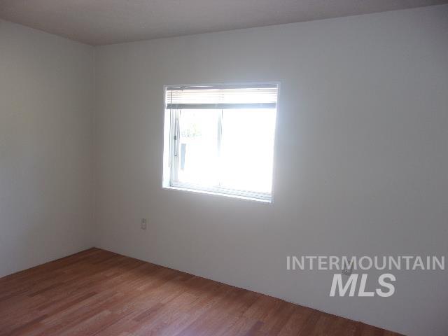 Empty room featuring wood finished floors