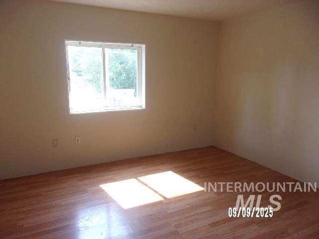 Empty room featuring wood finished floors
