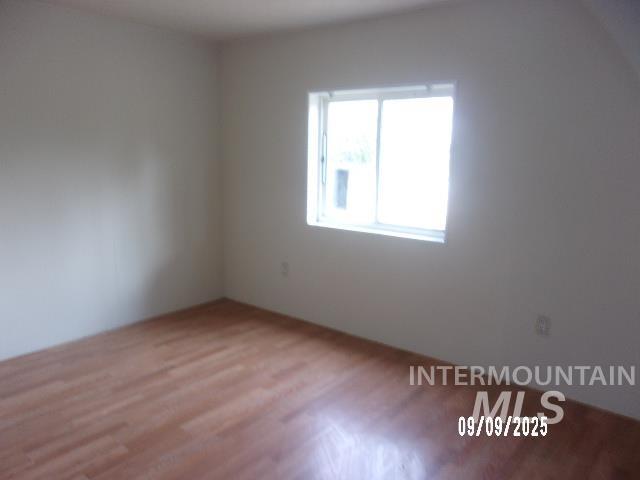 Spare room featuring wood finished floors