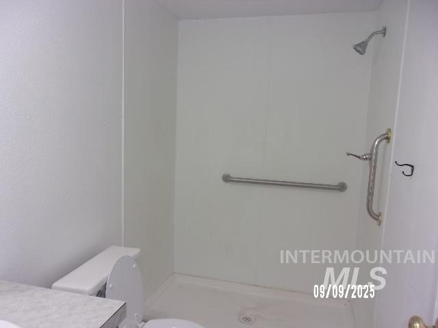 Bathroom featuring a shower stall and vanity