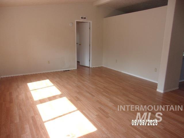 Unfurnished room featuring light wood-type flooring and baseboards