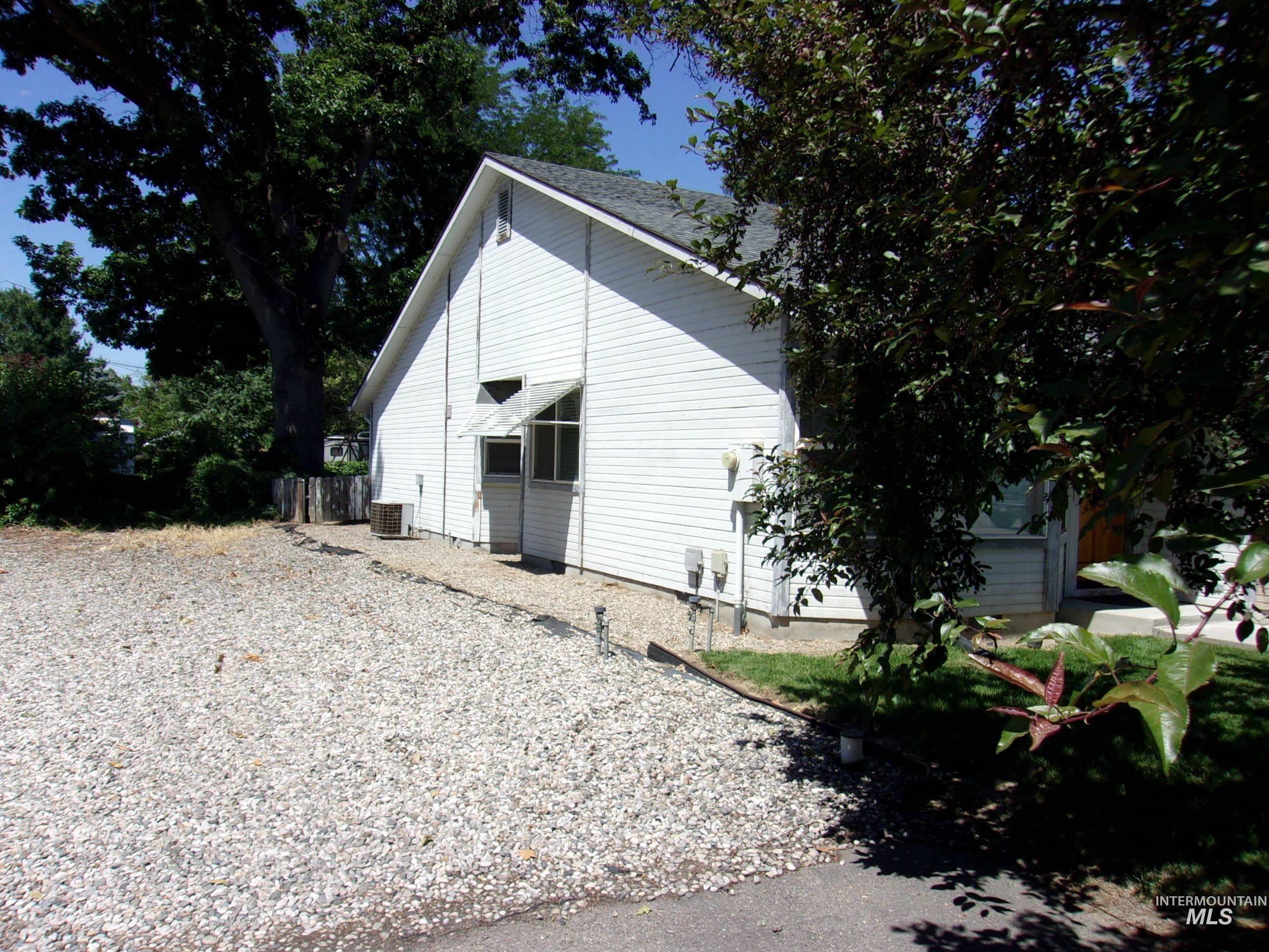 View of side of home with a cooling unit