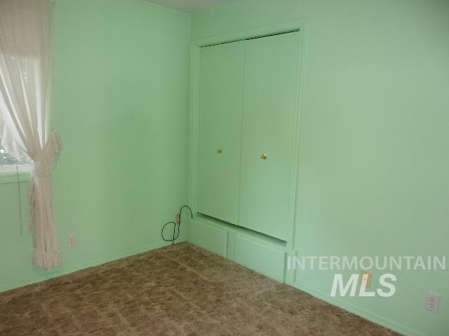 Unfurnished bedroom with a closet and carpet