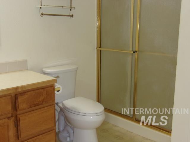 Full bathroom with a stall shower and vanity