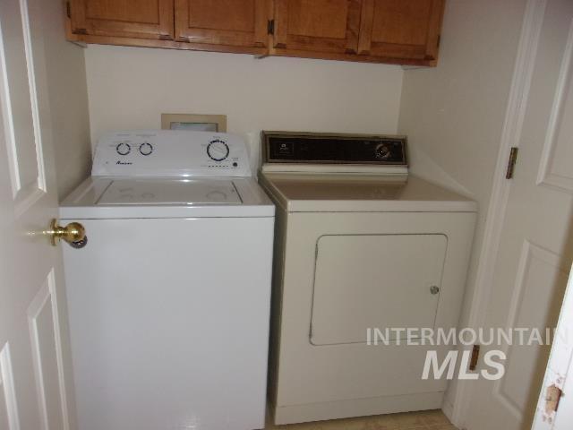 Laundry room with washing machine and clothes dryer and cabinet space