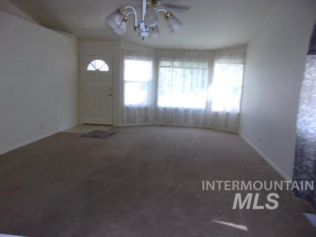 Foyer with carpet and a chandelier