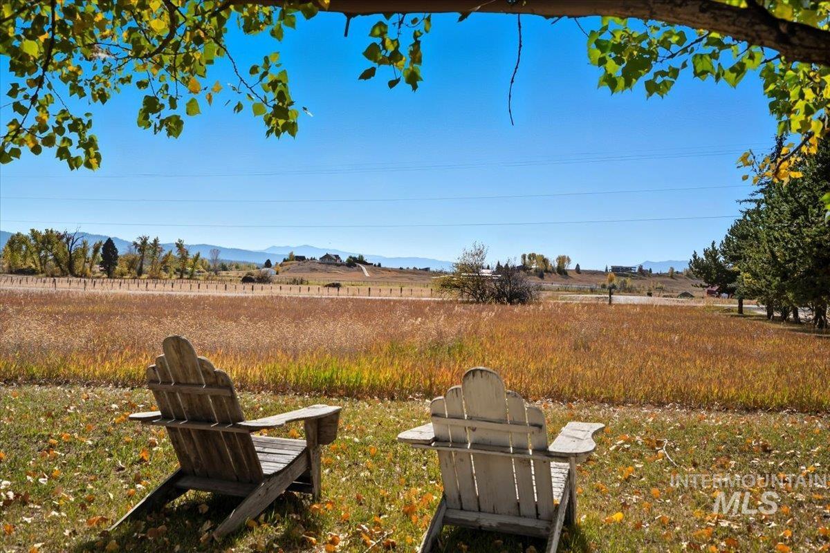 View of yard with a rural view and a mountain view