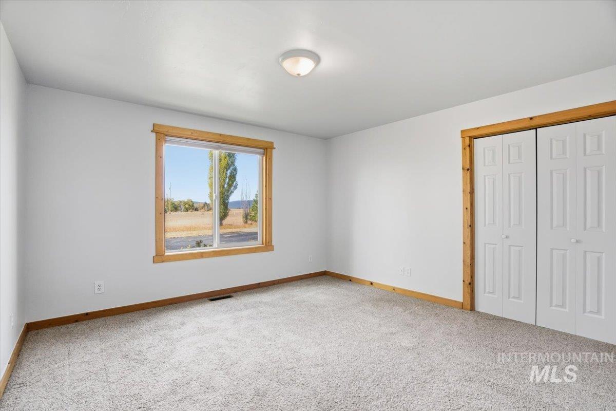 Unfurnished bedroom featuring a closet and light carpet