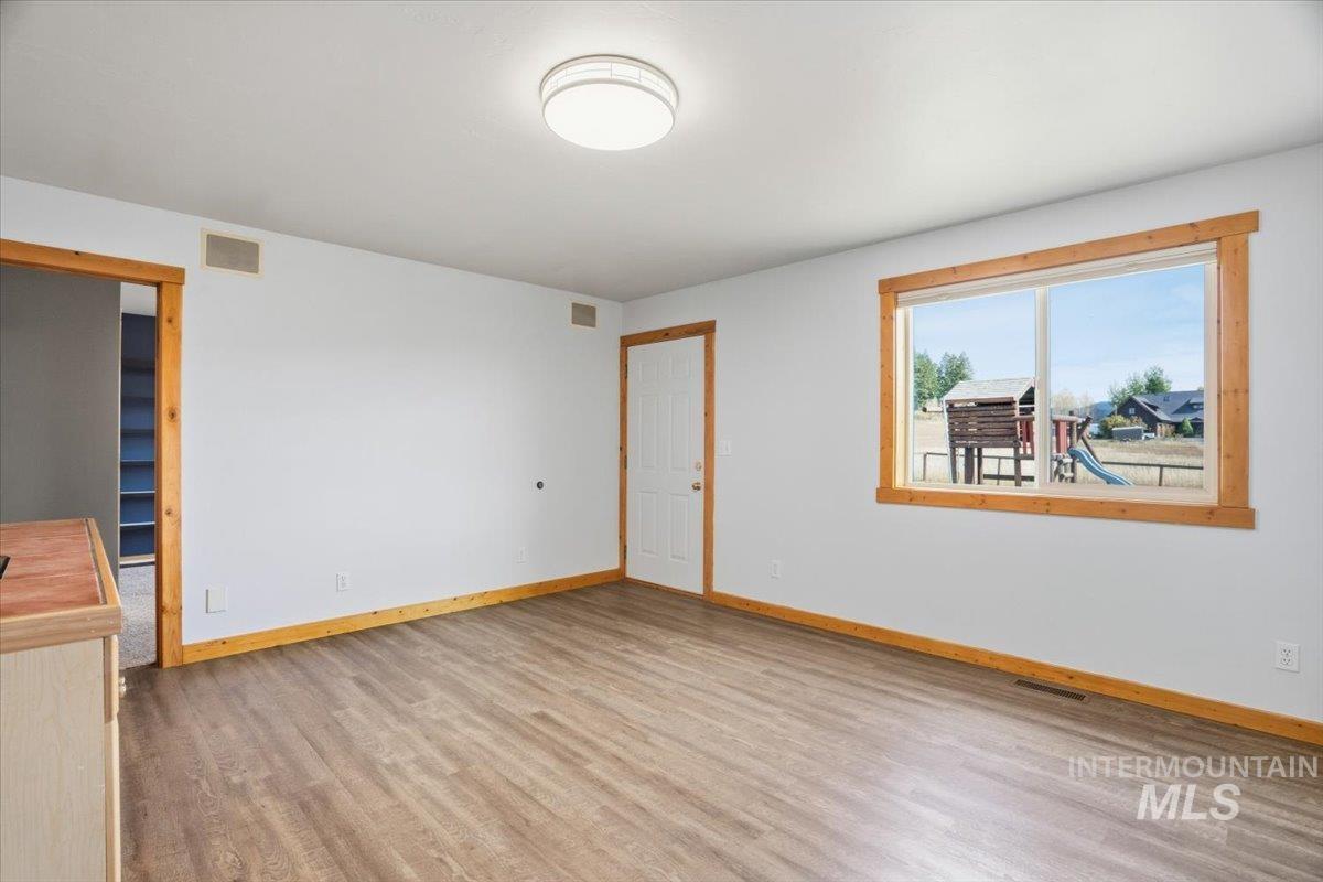 Spare room with light wood-style floors and baseboards