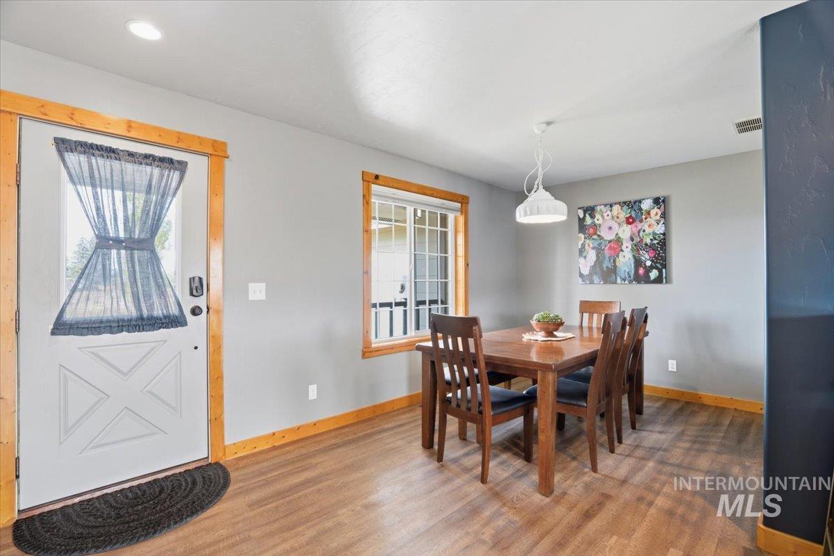 Dining space with plenty of natural light and light wood-style flooring