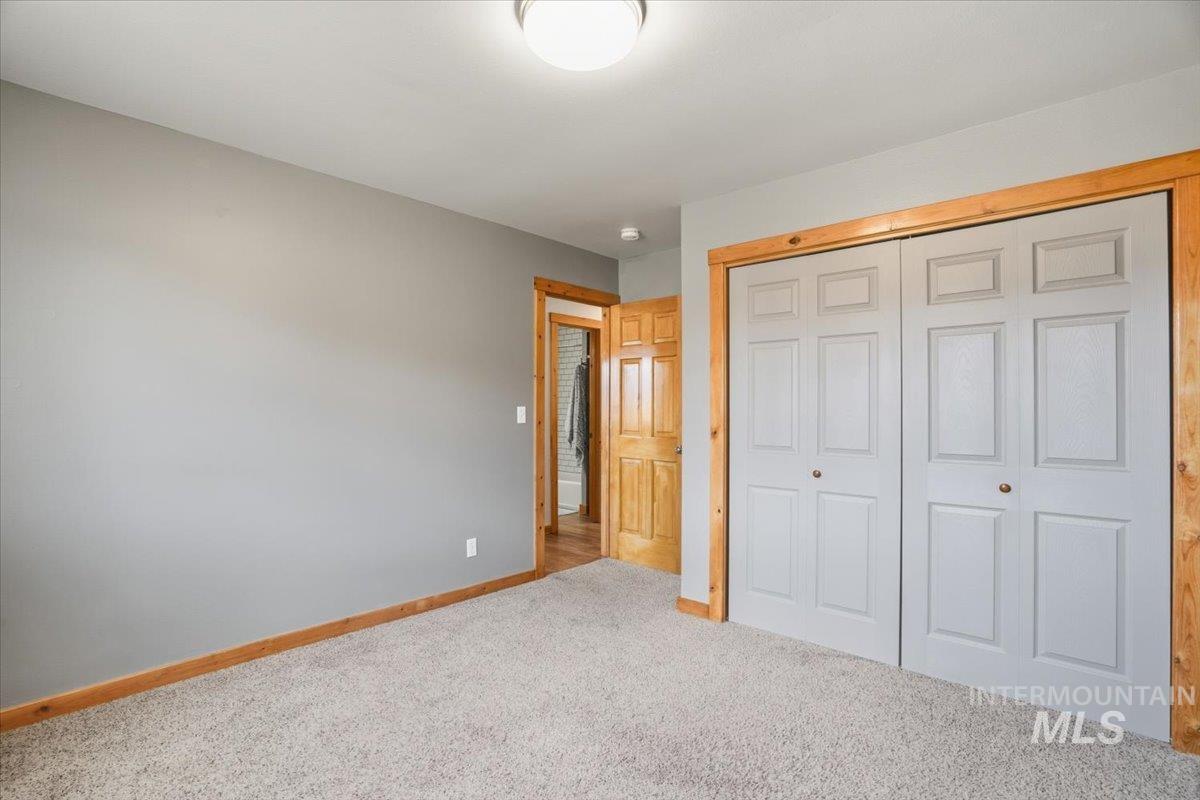 Unfurnished bedroom with carpet and a closet