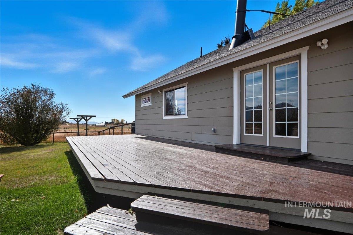 Wooden deck with a yard and french doors