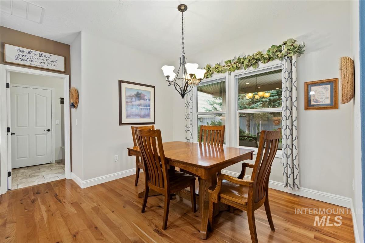 Dining space featuring light wood finished floors and a chandelier