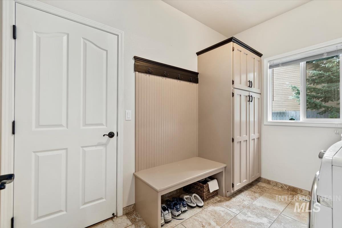 Mudroom featuring baseboards and light tile patterned floors