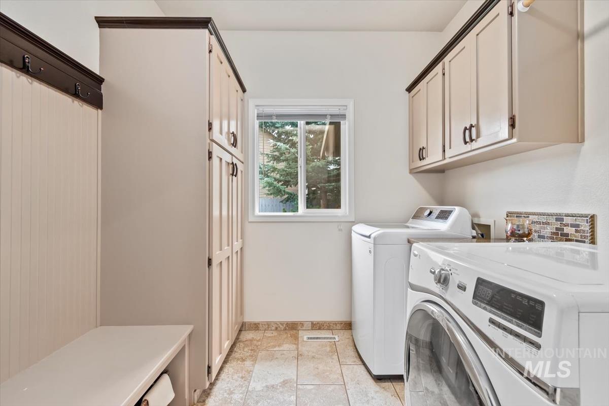 Laundry room with washing machine and clothes dryer and cabinet space