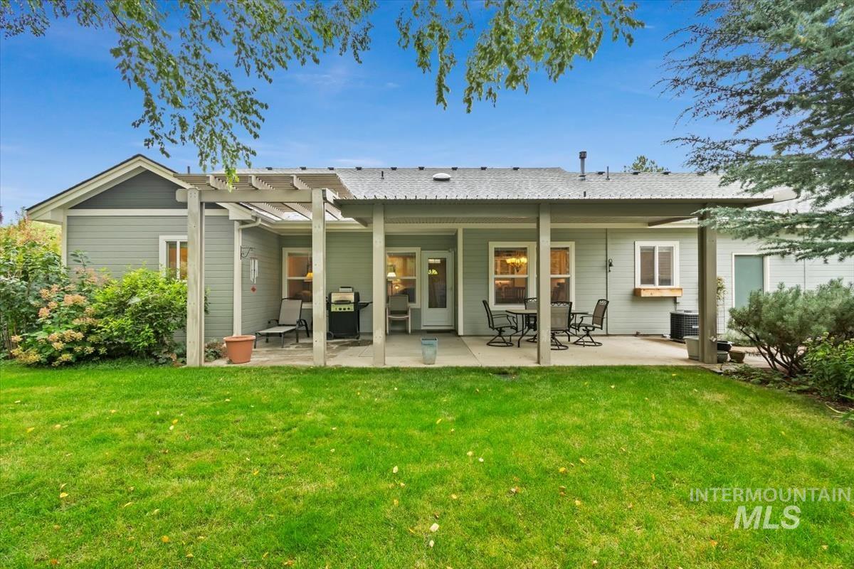 Rear view of house with a yard and a patio area
