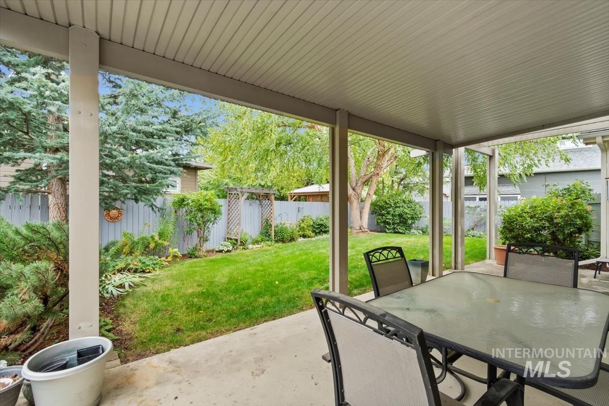 Fenced backyard featuring outdoor dining area and a patio