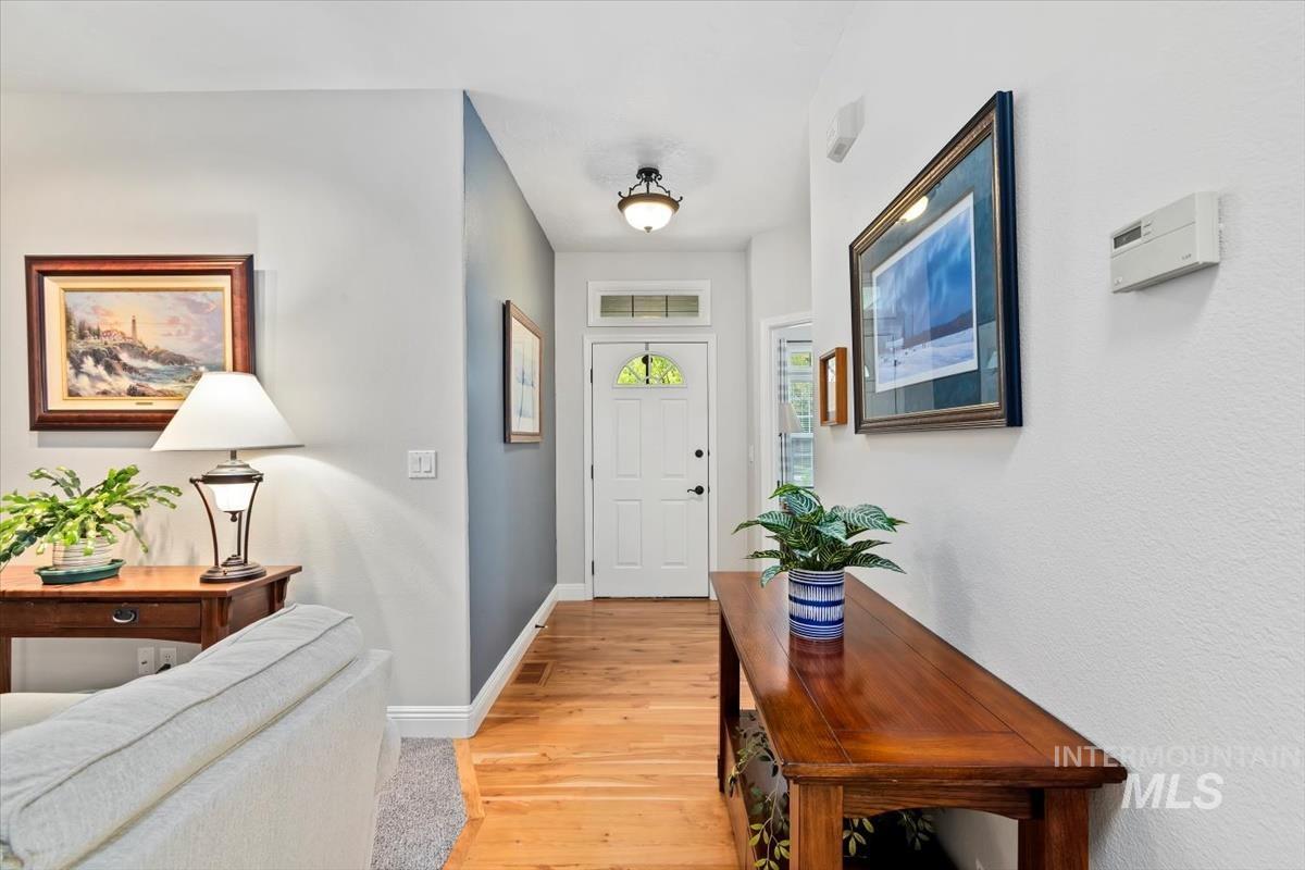 Foyer featuring light wood-type flooring and baseboards