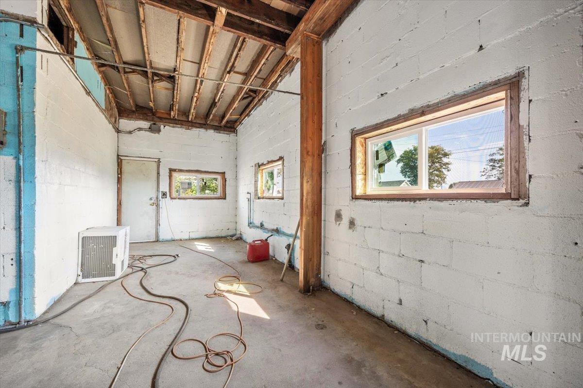 Basement with healthy amount of natural light and concrete block wall