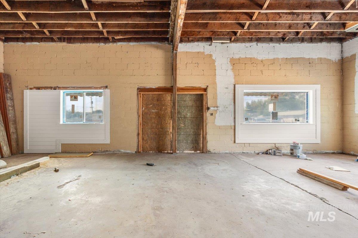 Misc room with unfinished concrete floors