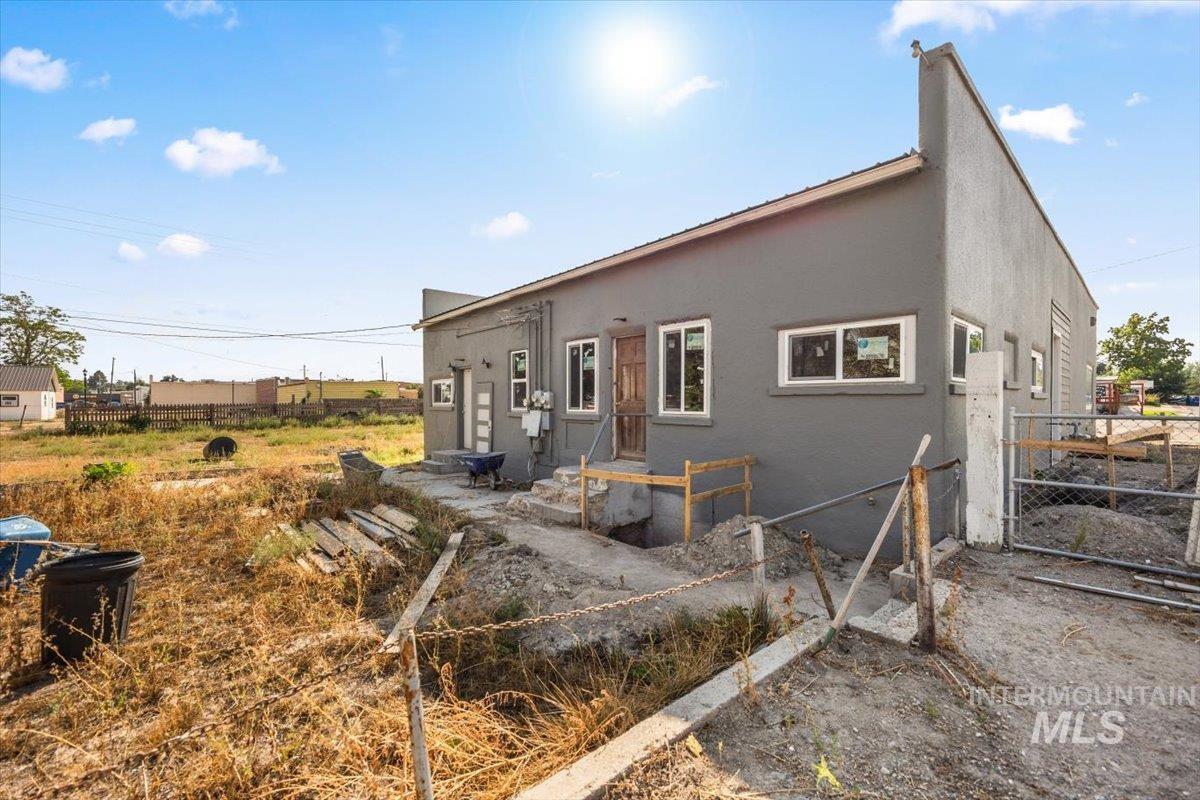 Back of house featuring stucco siding and entry steps