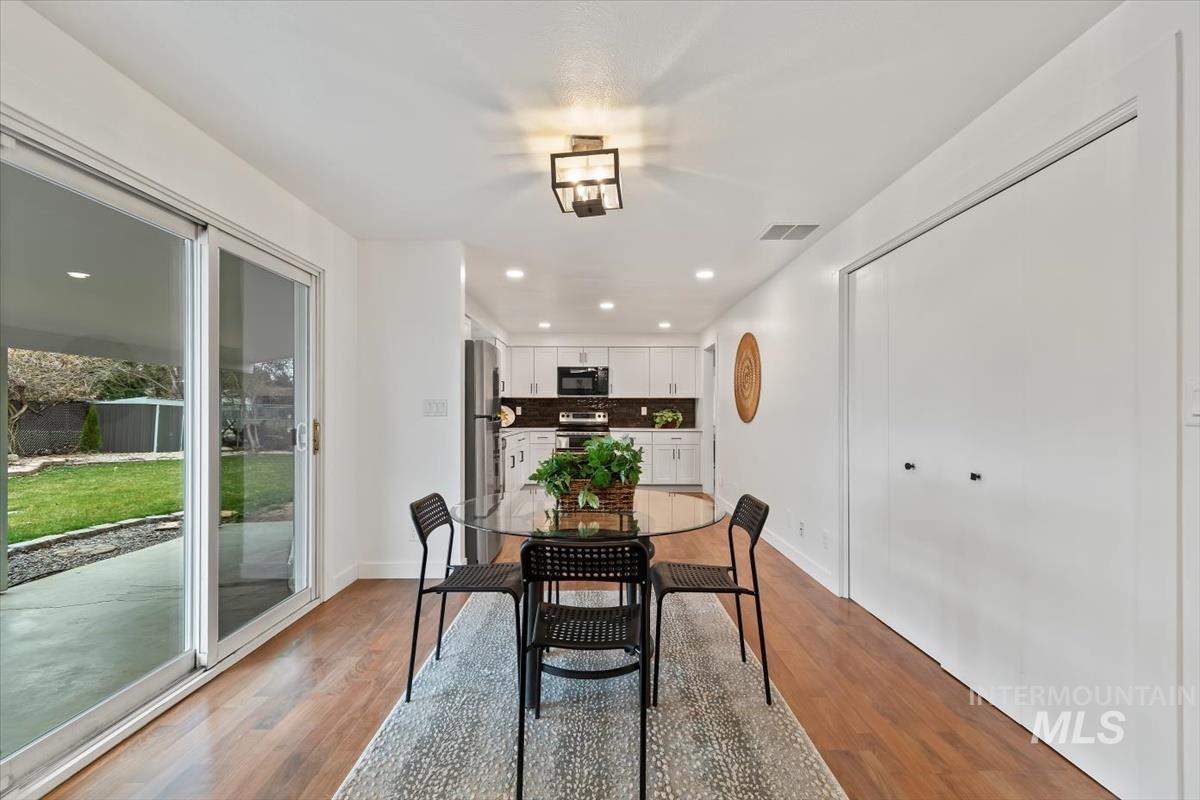 Dining space with recessed lighting and light wood-type flooring