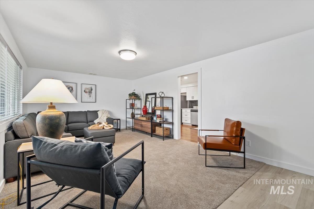 Living area featuring light wood-style floors and baseboards