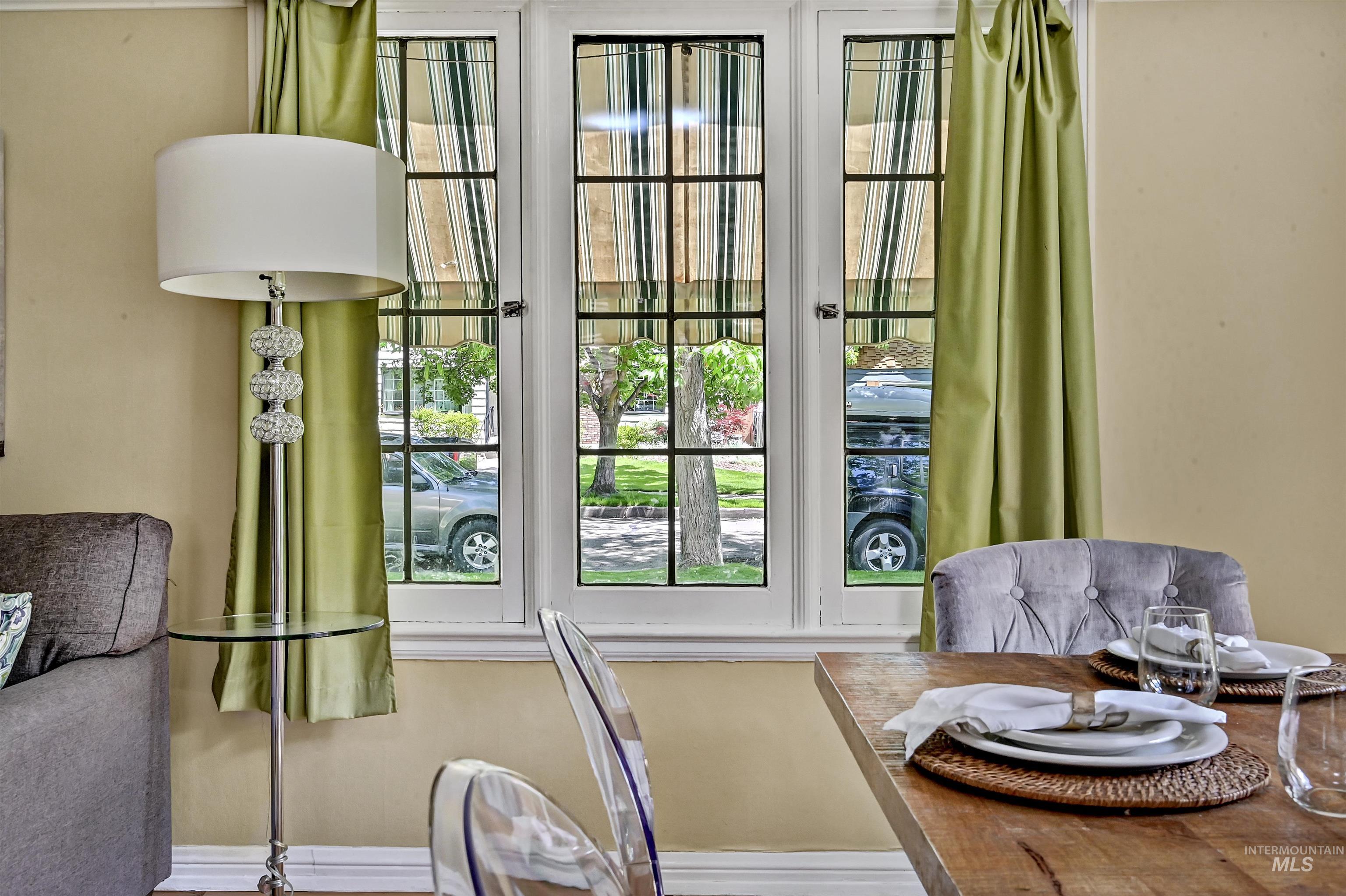 Charming nook with multi-pane windows & deep sills that frame leafy street views, filling the space with natural light & character.