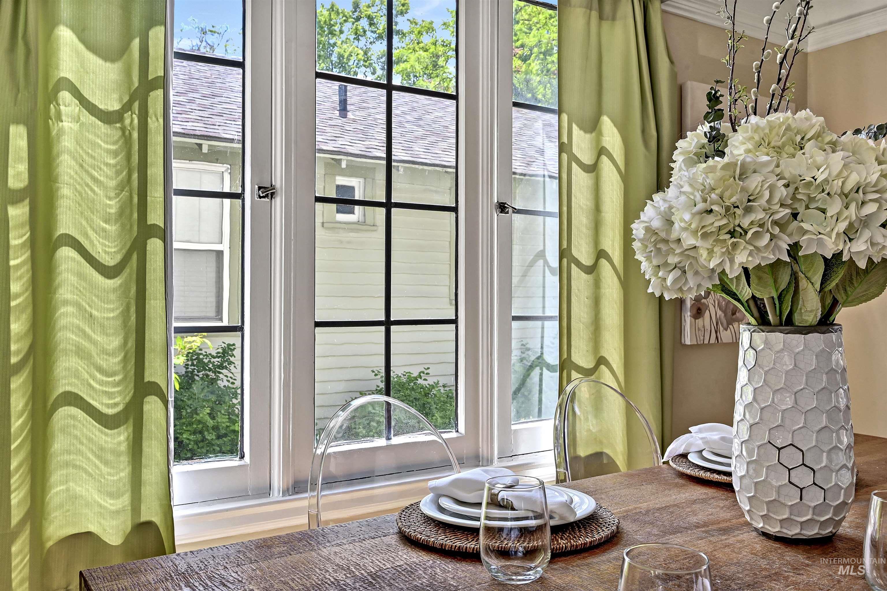 Charming nook with multi-pane windows & deep sills that frame leafy views, filling the space with natural light & character.