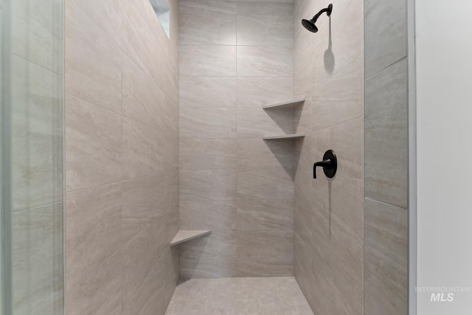 Full bathroom featuring a tile shower